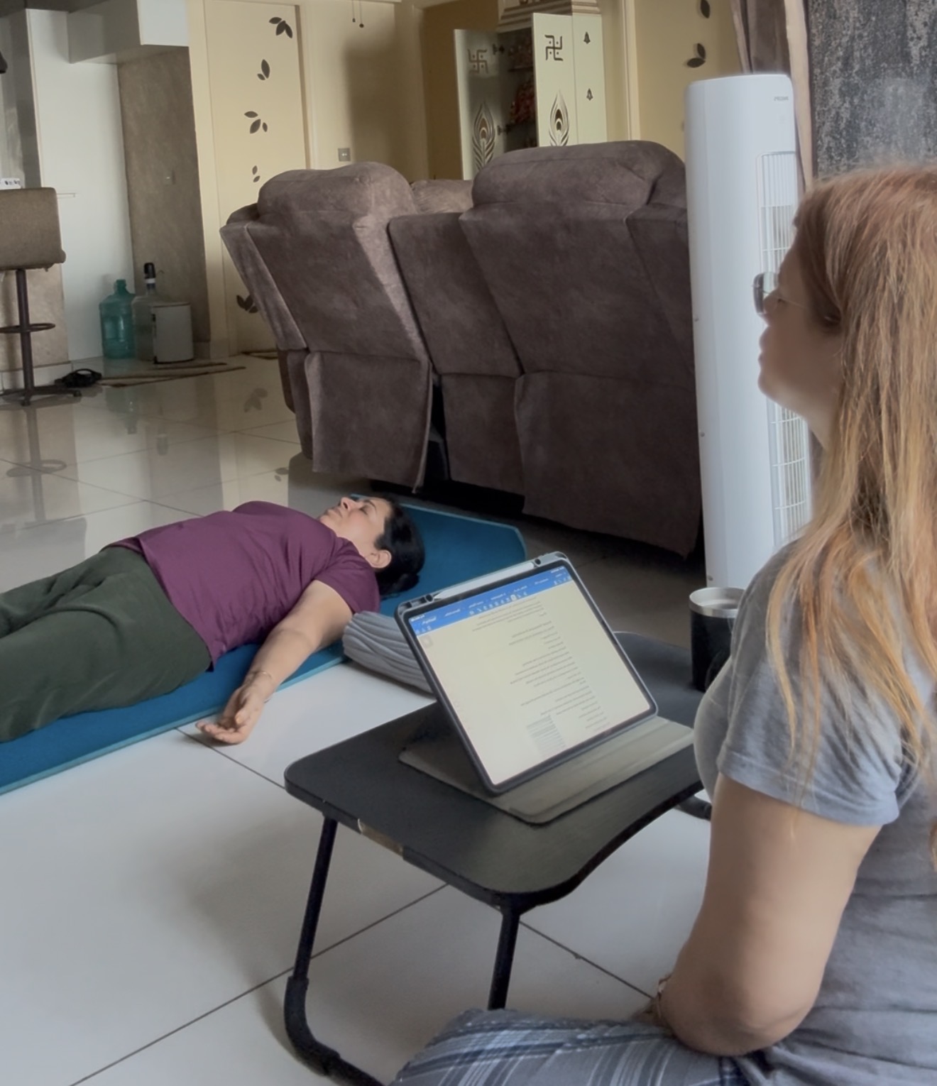 Diksha guiding a client through Yoga Nidra with a gentle hand placement